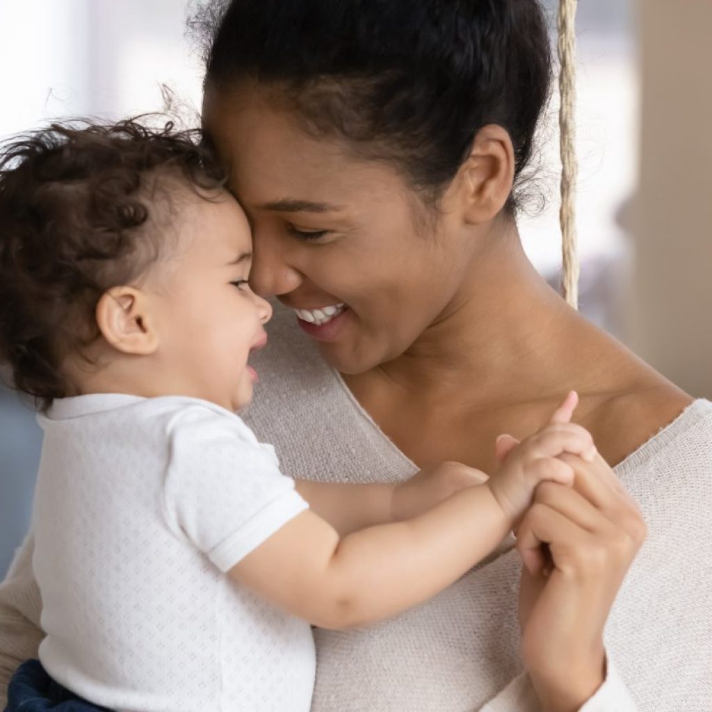Woman holding a baby.