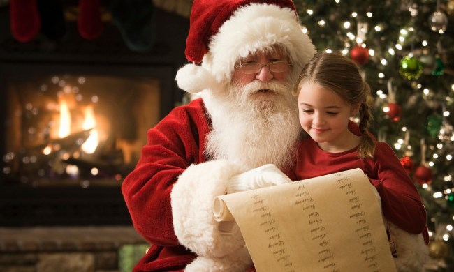 Santa sitting with a little girl going over the list.