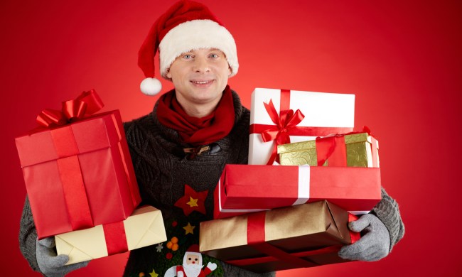 A young man holding Christmas packages