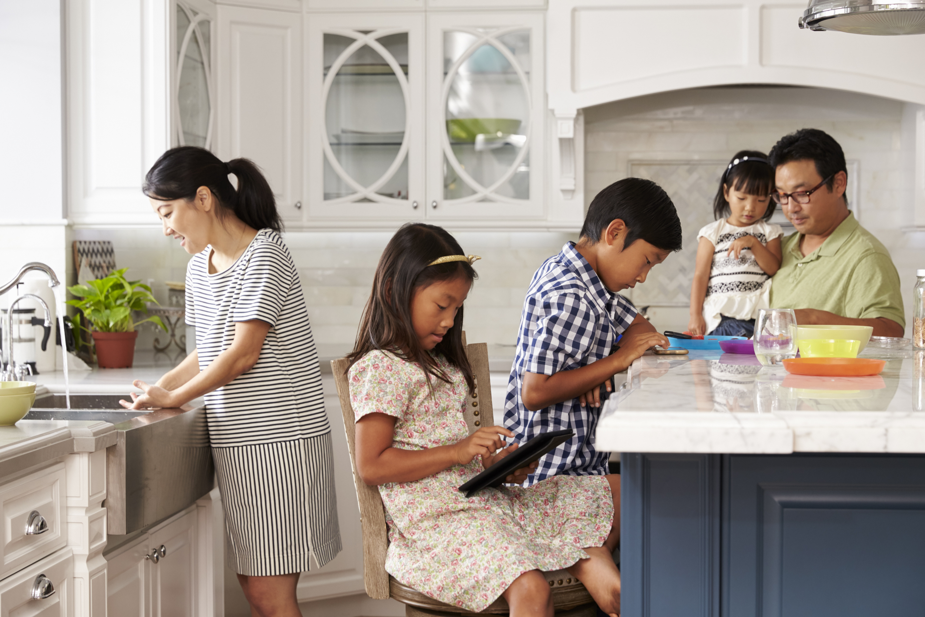 A family gathered in the kitchen.