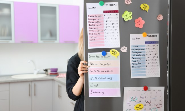 A family calendar hanging on the fridge