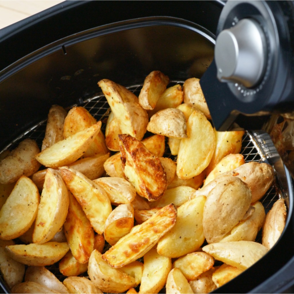 Potatoes cooking in an air fryer