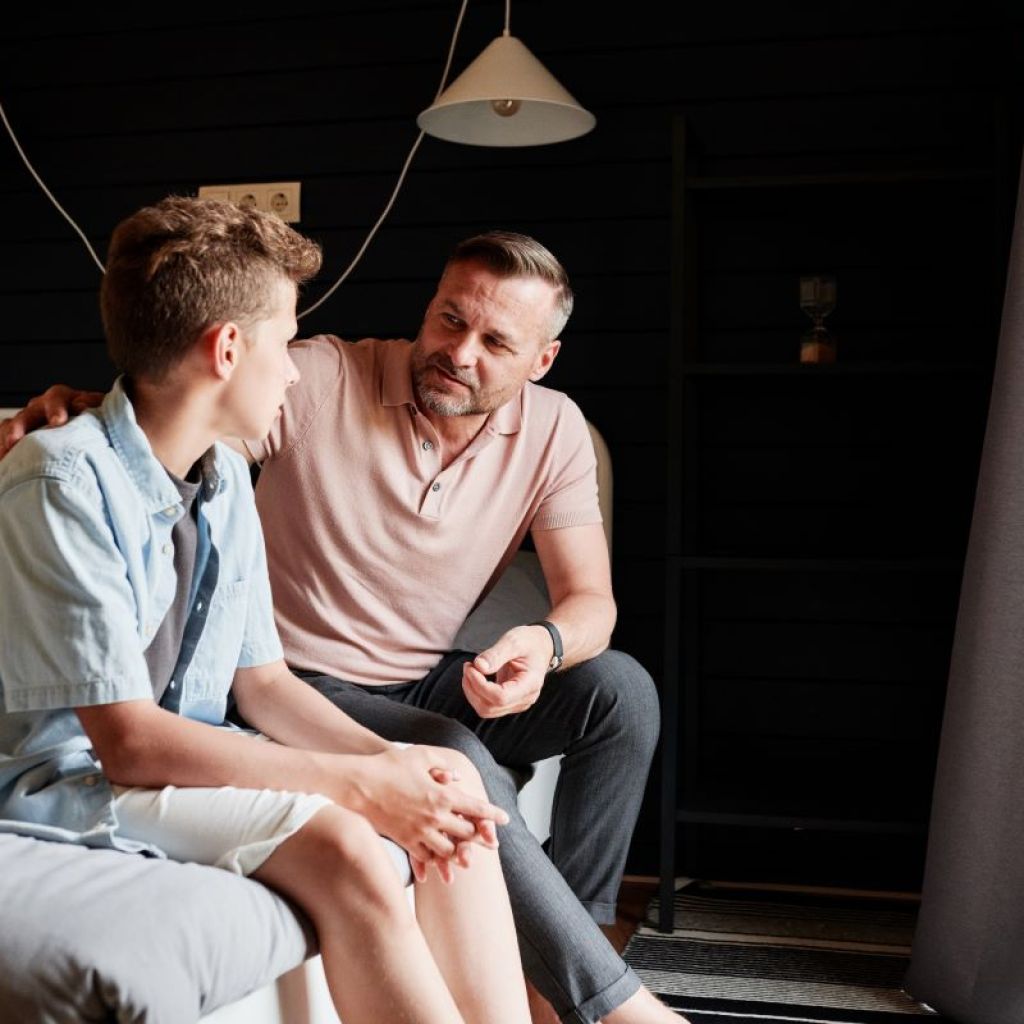 Father talking to teenage son