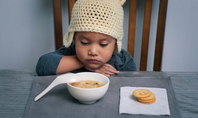 A toddler not wanting to eat their food