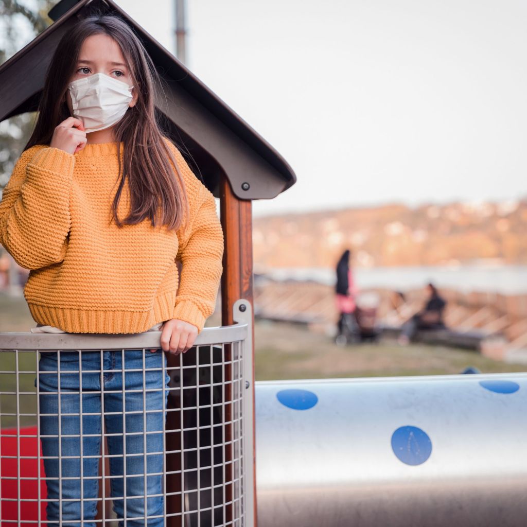 girl-in-mask-playing-at-playground