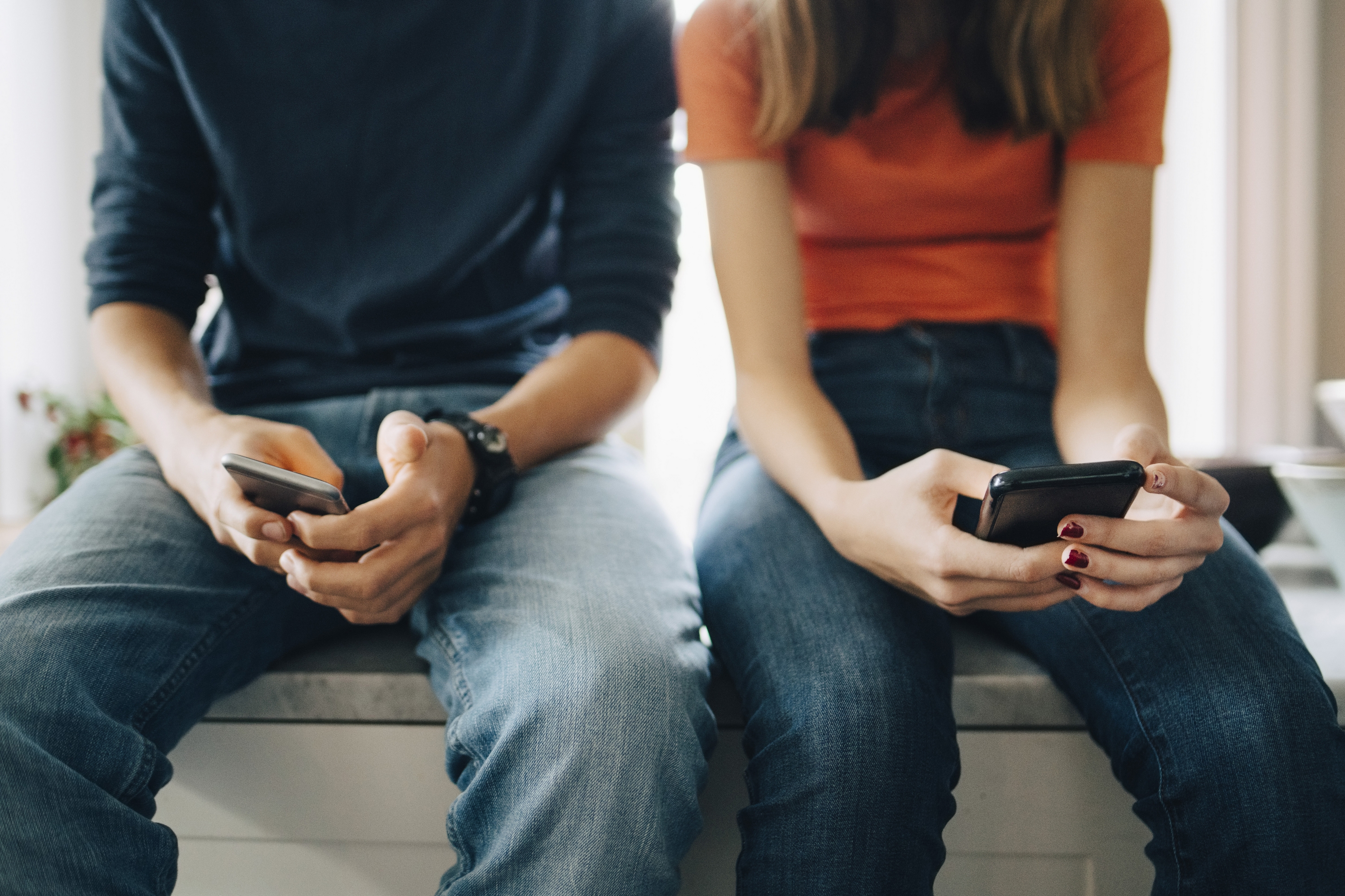 boy-and-girl-looking-at-tiktok-on-phones
