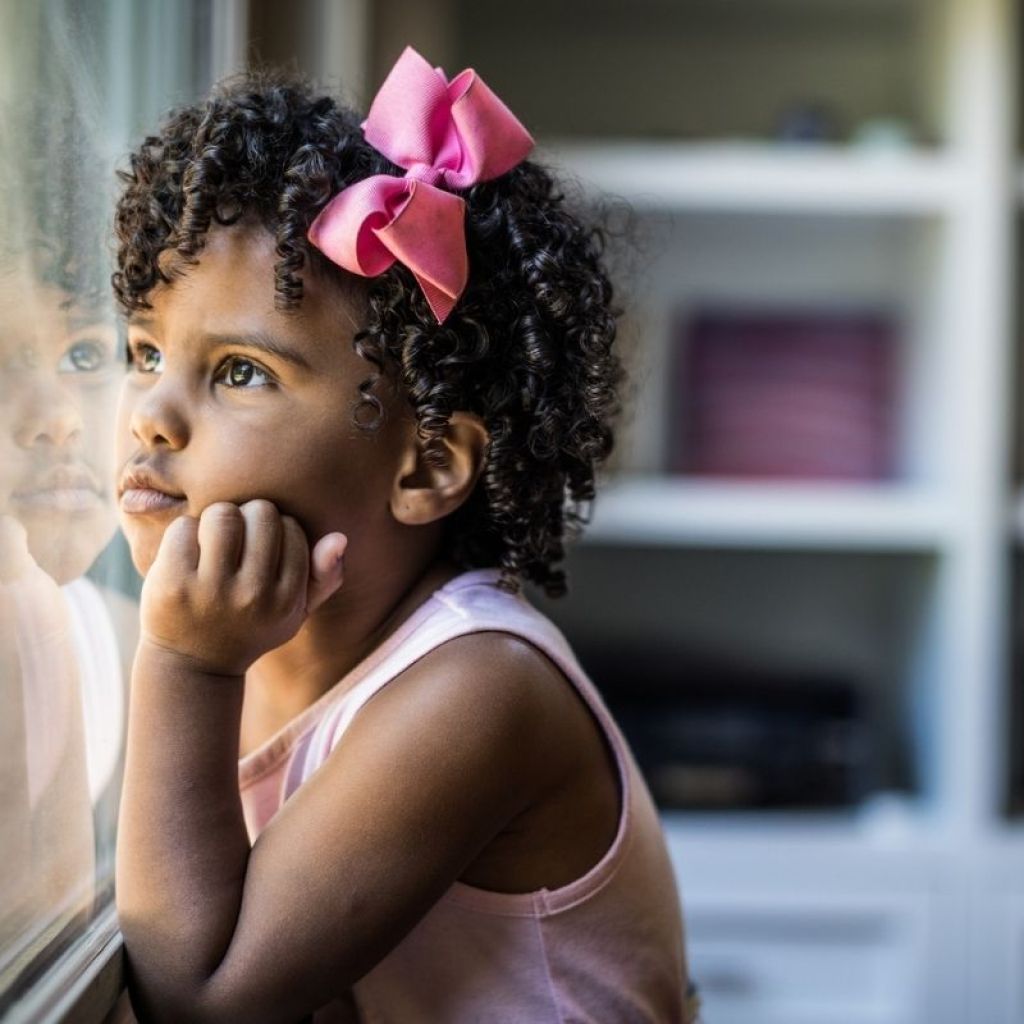 preschool girl dreaming looking out window