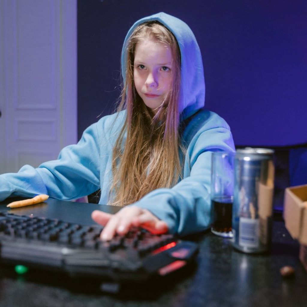 Teen girl playing game on the computer