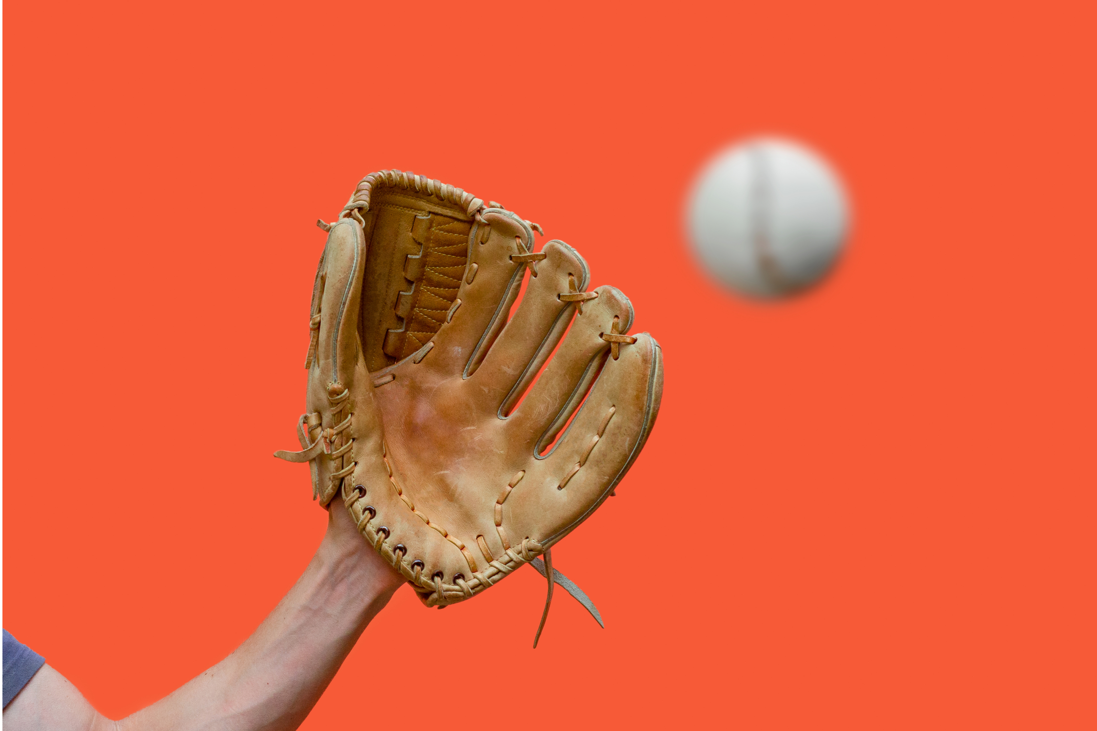 An open baseball glove ready to make a catch