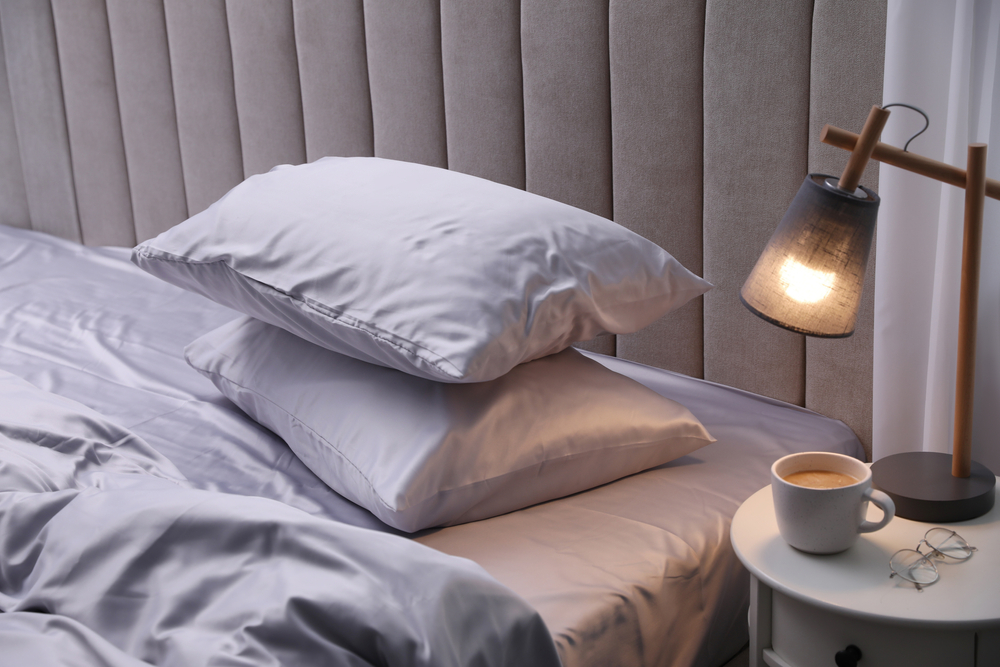 Bedside with lamp and pillows