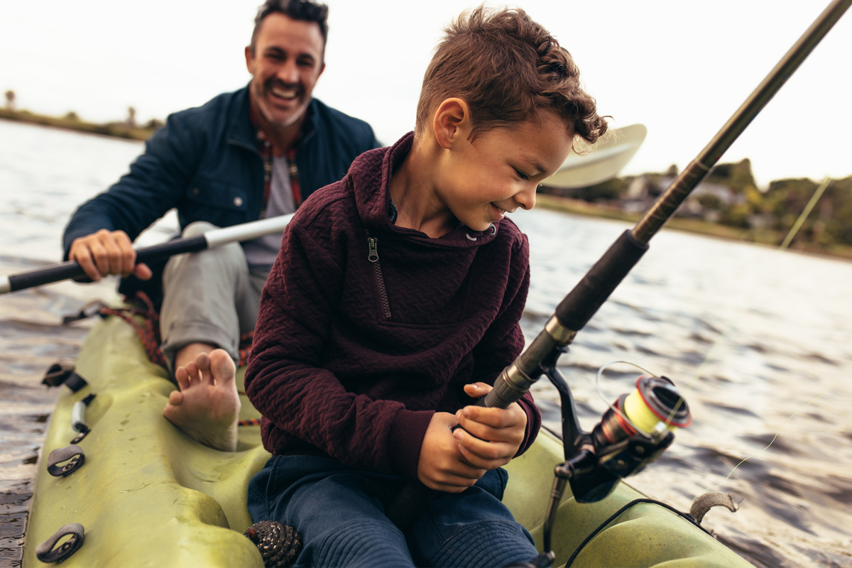 father and son in a kayak fishing