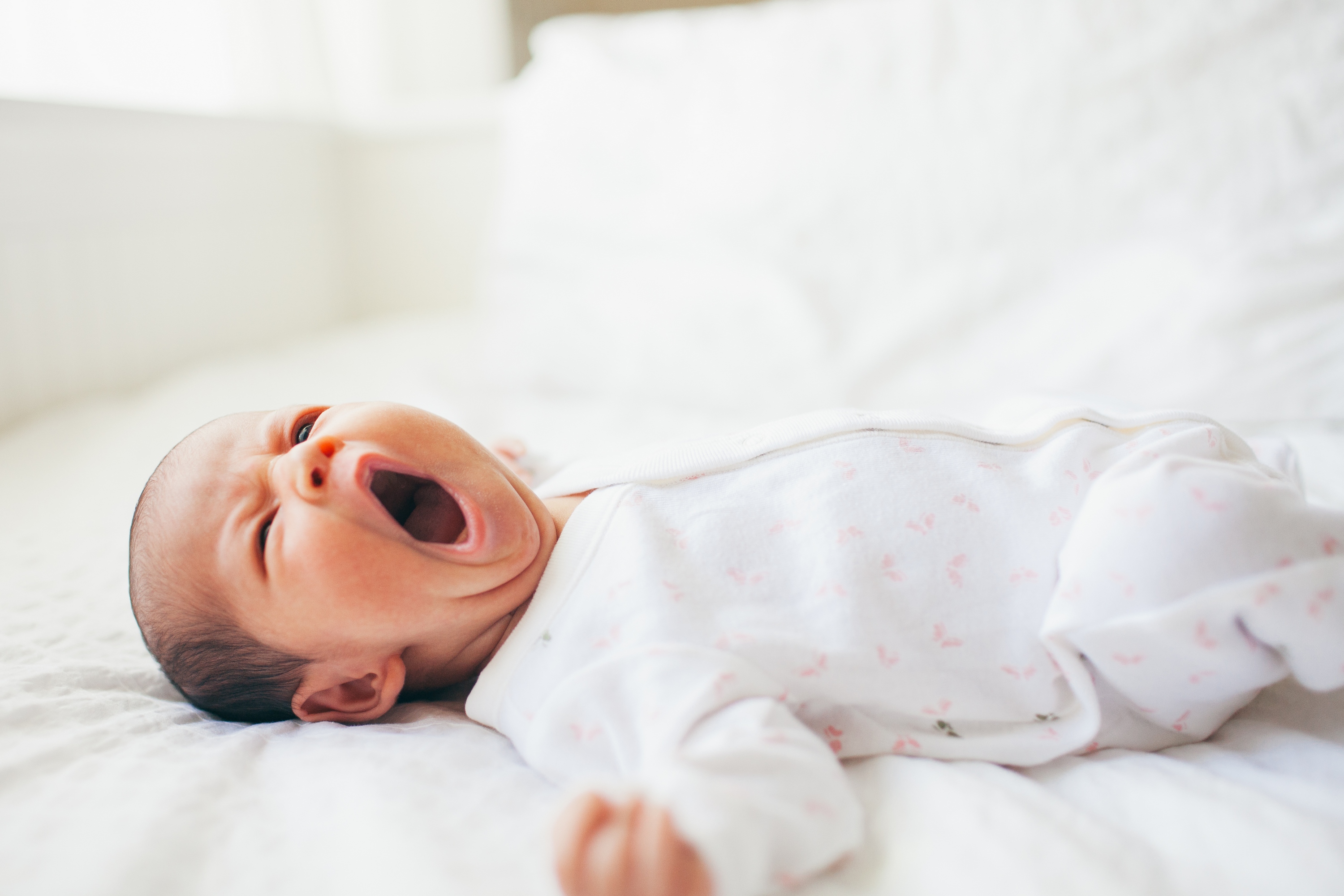 Baby yawning in crib