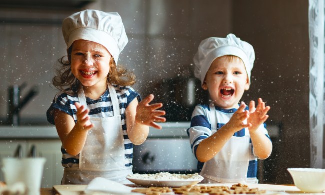 Two kids having fun baking in the kitchen.