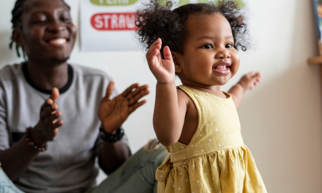 Toddler girl and her dad having fun with music and movement activity.