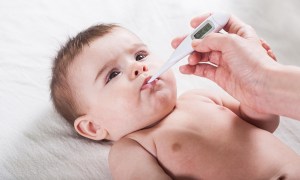 Baby with a thermometer