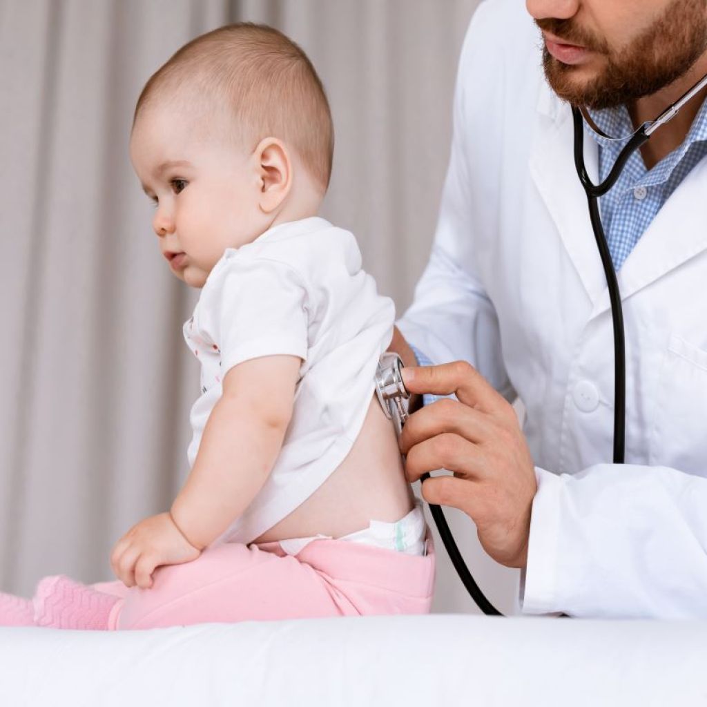 Doctor listening to baby breathing