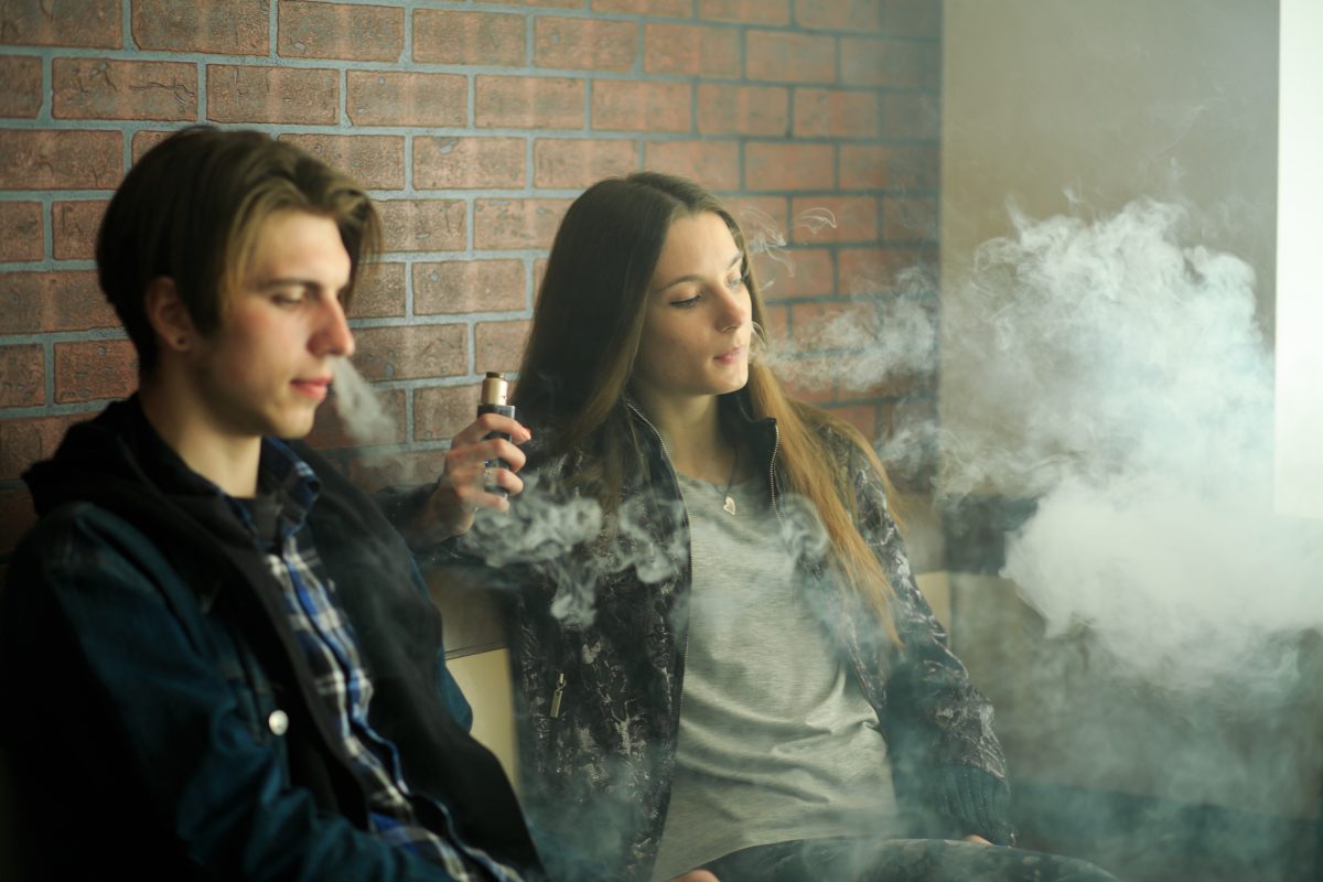 A couple of teens vaping