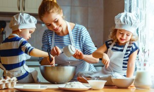 Nanny and kids baking a cake