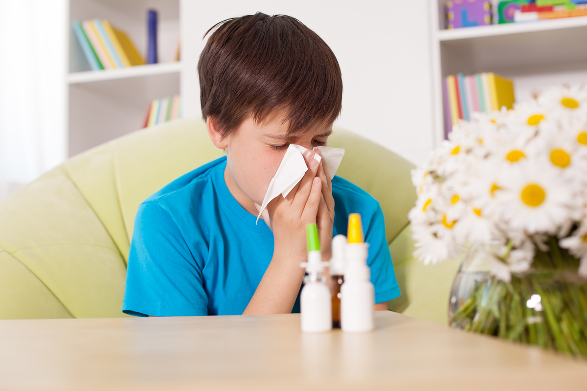 Boy using nasal sprays and eye drops to help ease allergy symptoms