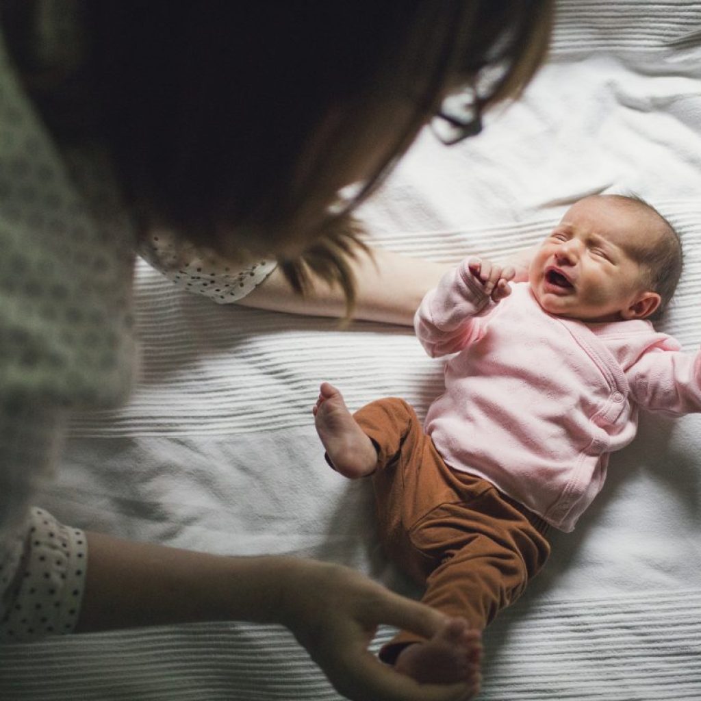 Parent taking care of a fussy little baby