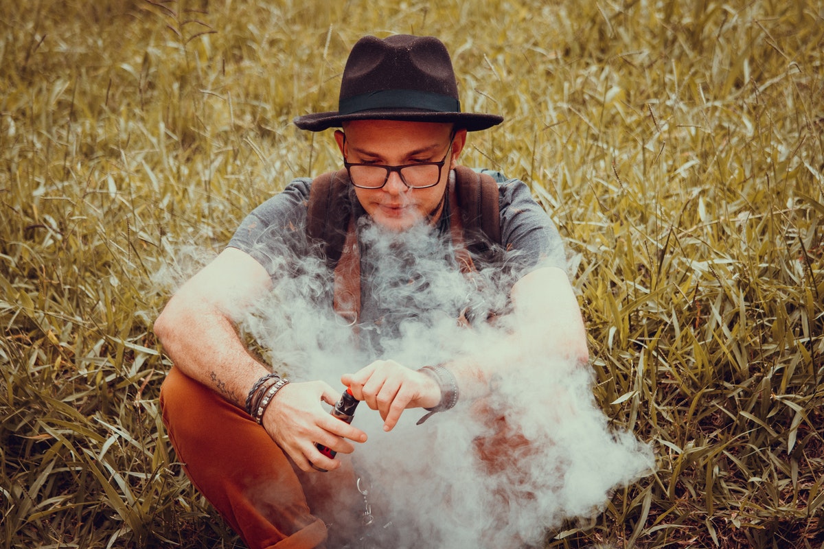 Teen sitting and vaping