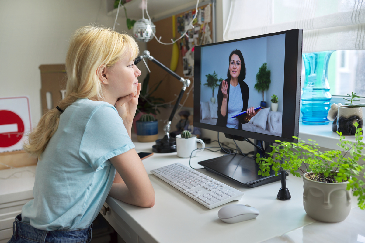 teen girl doing an online therapy session at home