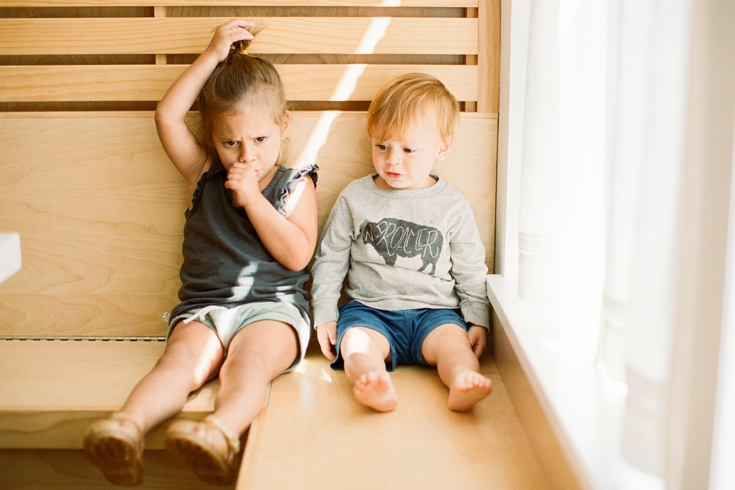 Toddler pulling her hair and sucking her thumb.