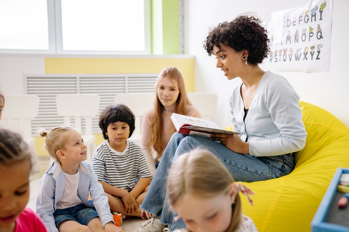 Teachers reading a story to the class.