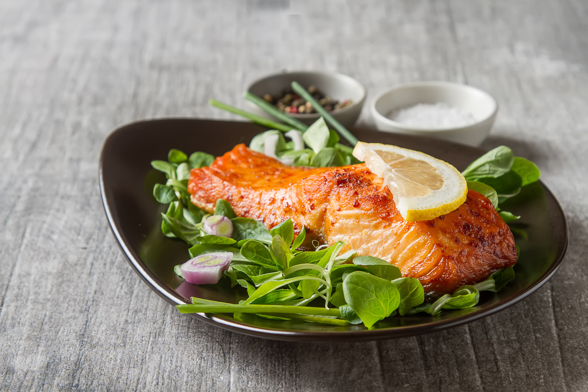Lemon garlic salmon dish on a plate with spinach