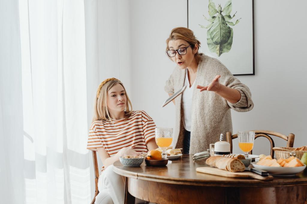 Parent scolding teen about electronic device