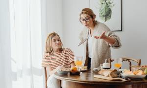 Parent scolding teen about electronic device