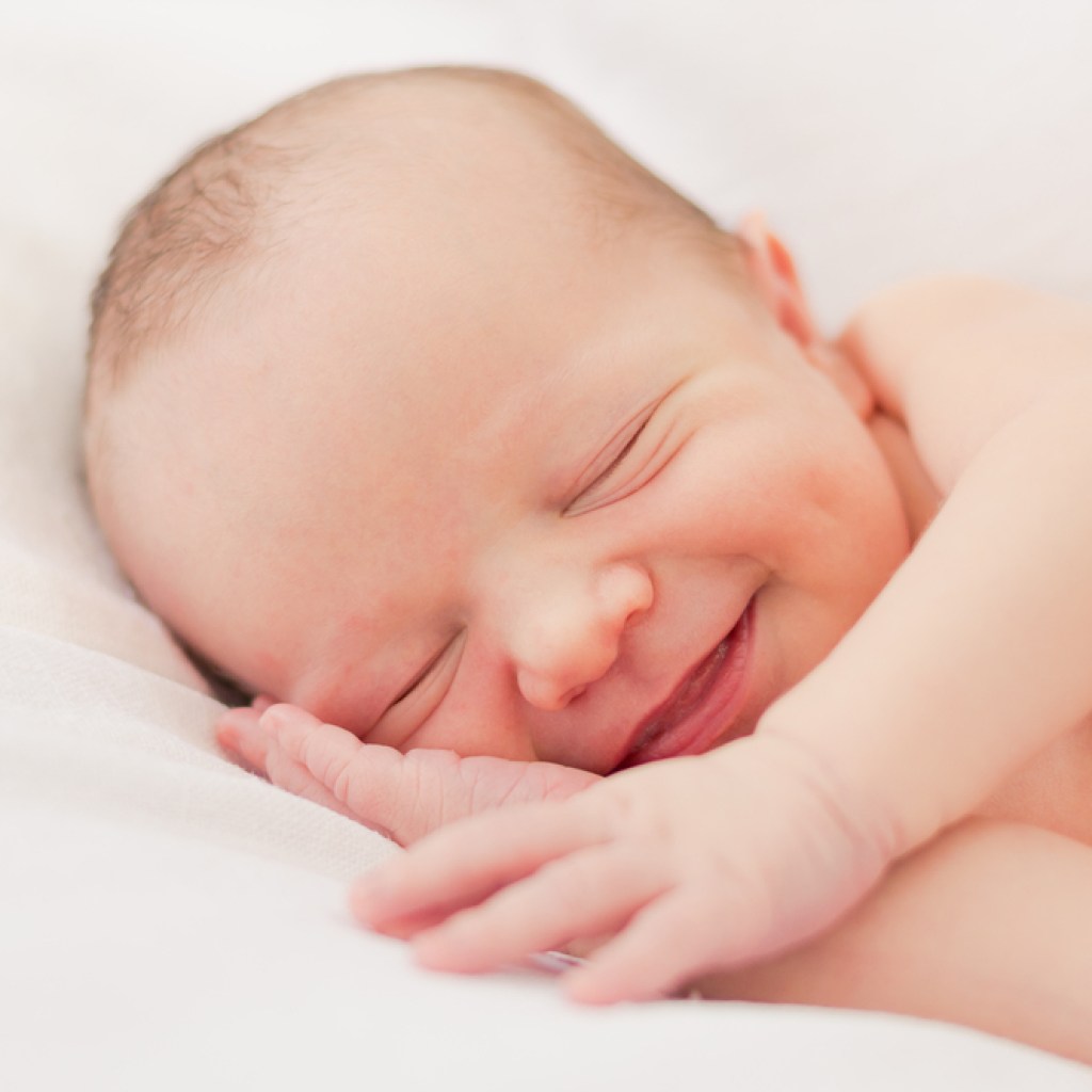 Newborn smiling while asleep