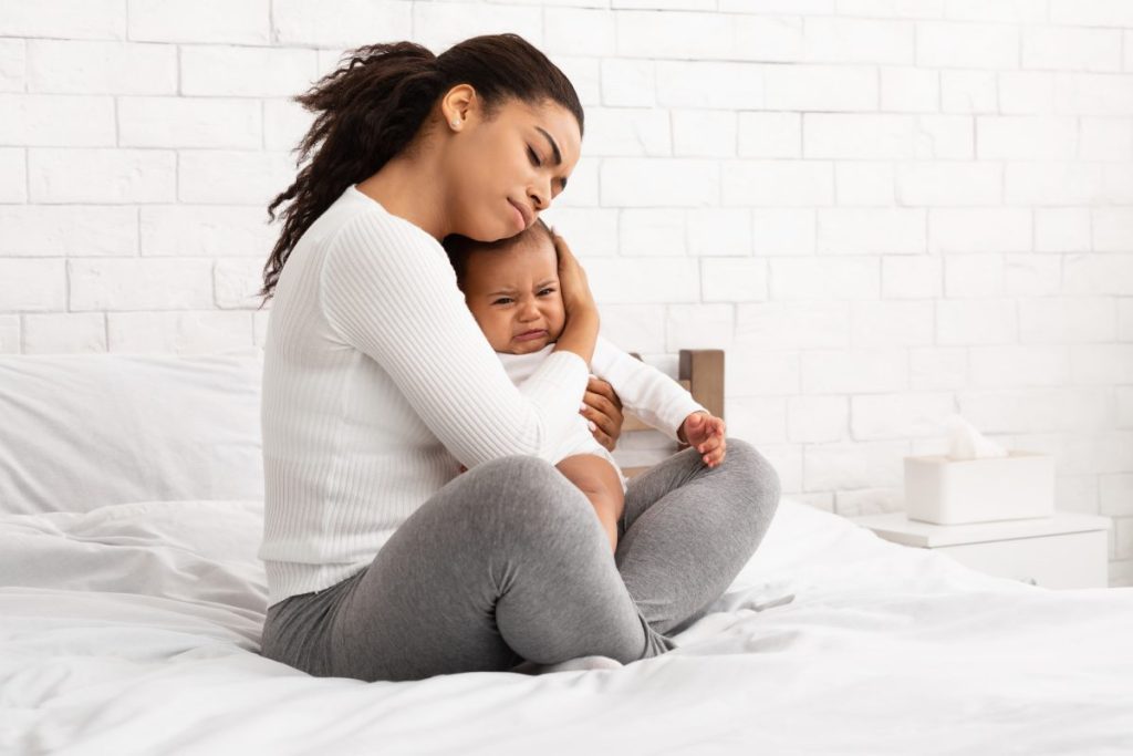 A mother comforting a crying baby