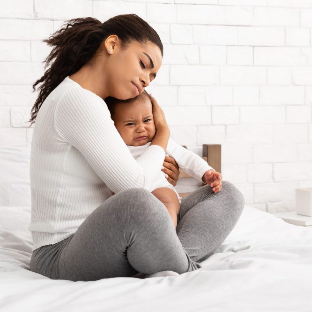 A mother comforting a crying baby