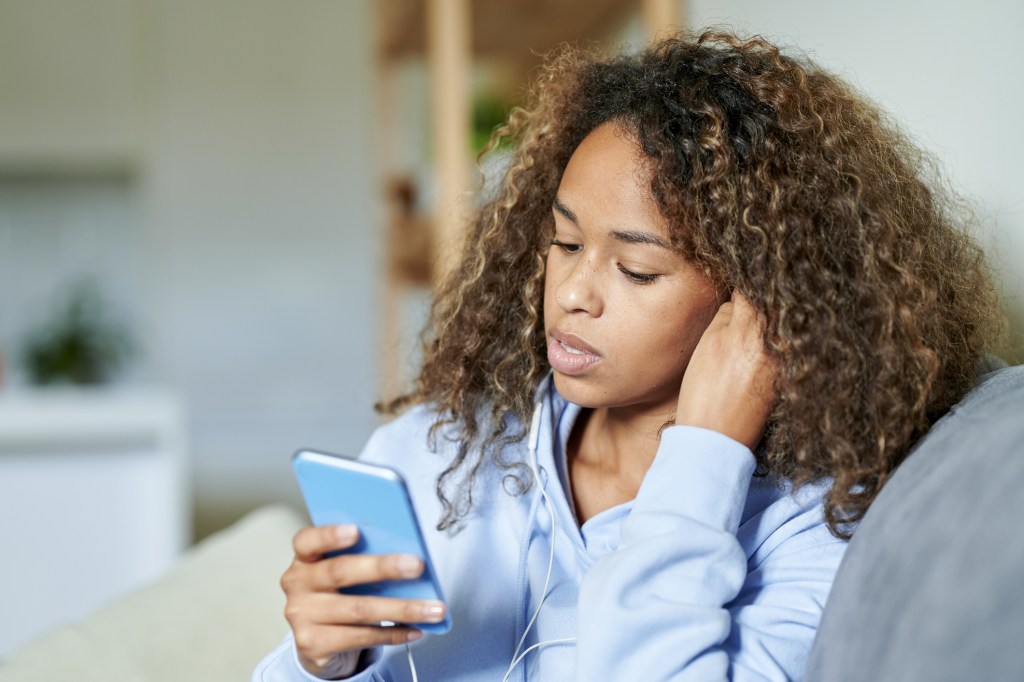woman deleting period tracker app from her phone