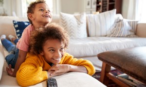 A couple of siblings watching TV together