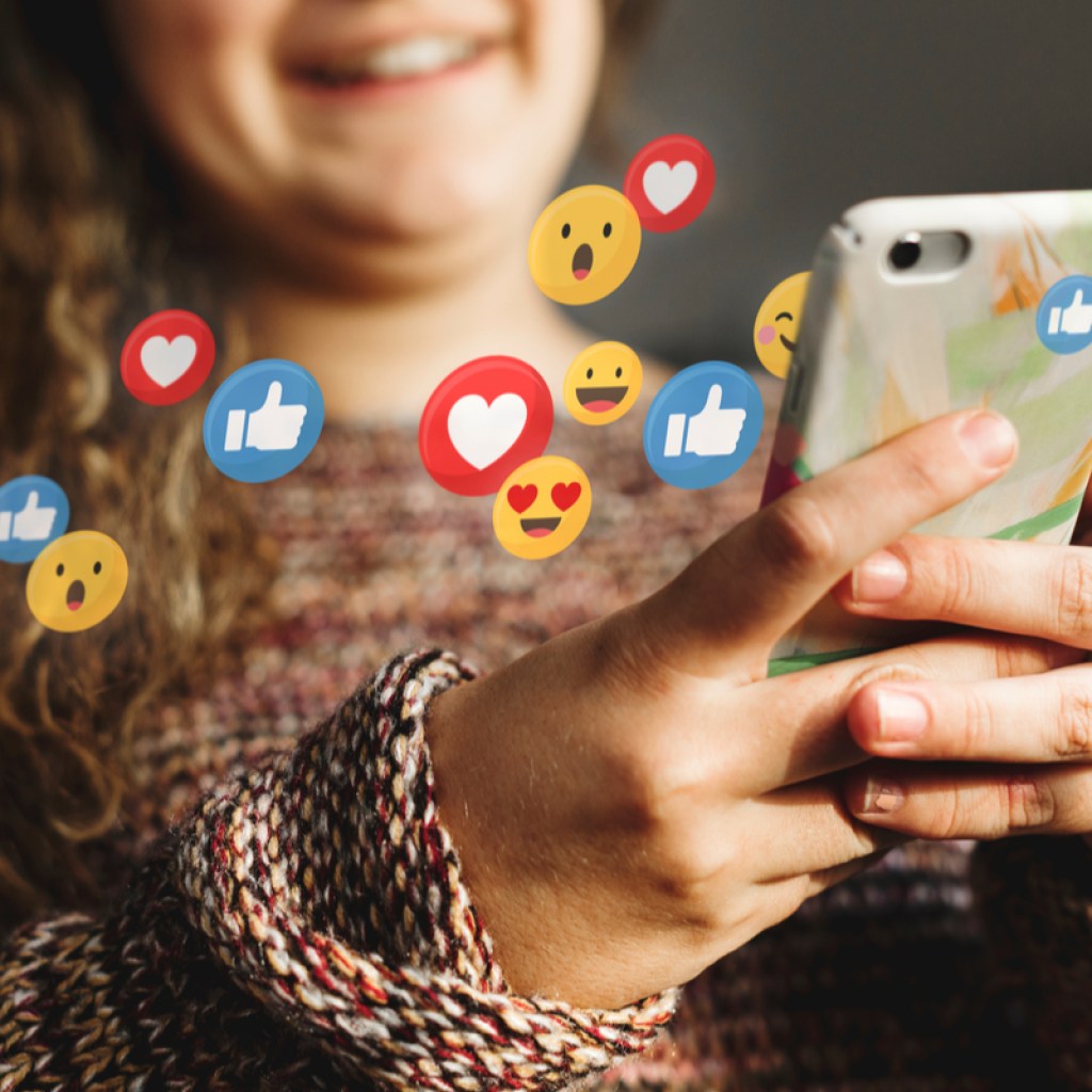 A teen using social media on her cell phone.