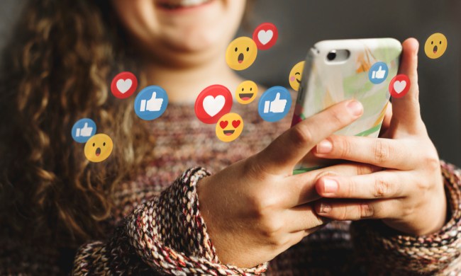 A teen using social media on her cell phone