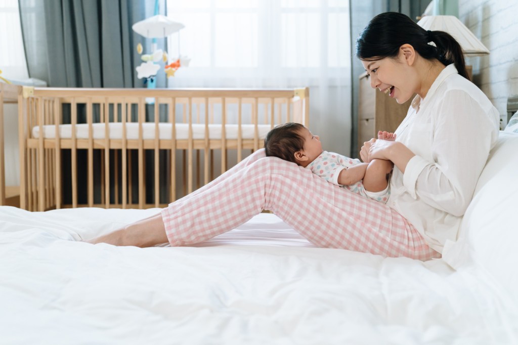 A mother singing to her little baby.