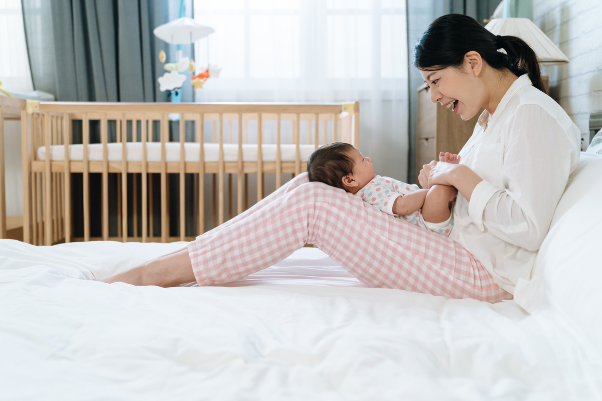 A mother singing to her little baby.