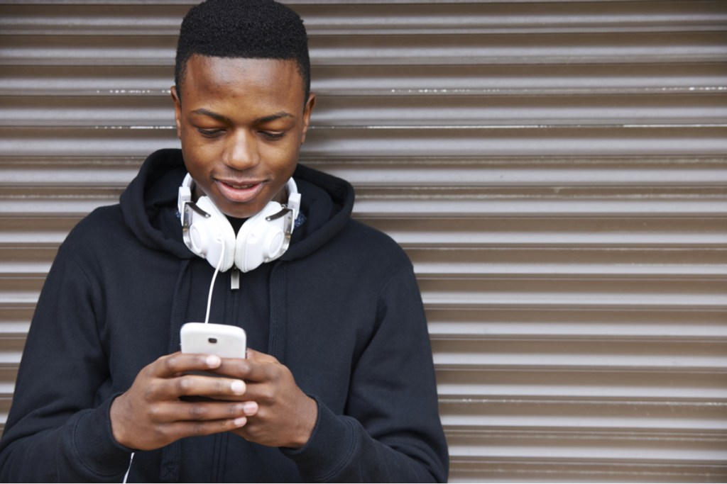 A male teen on his cellphone.