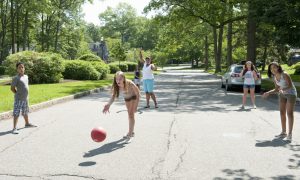 A group of kids playing kickball.