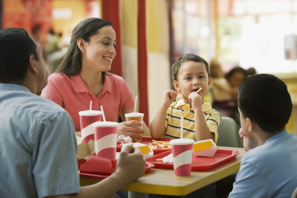 A family enjoying a fast-food meal together