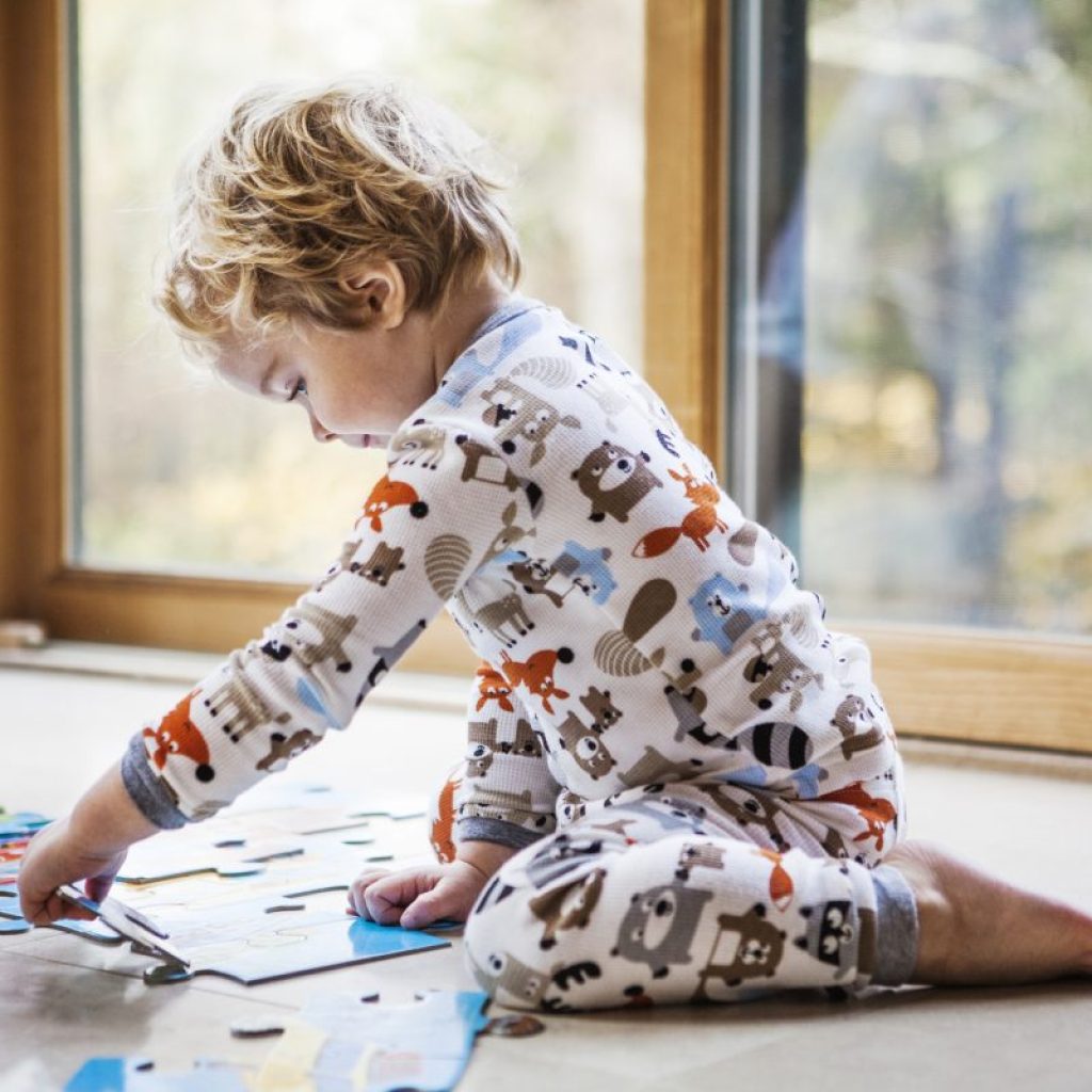 A toddler putting together a puzzle.