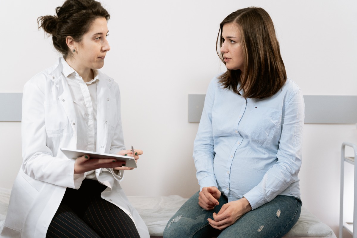 Pregnant person asking doctor questions.