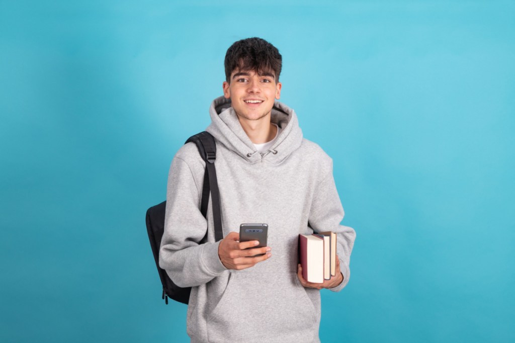 Happy teen boy at college