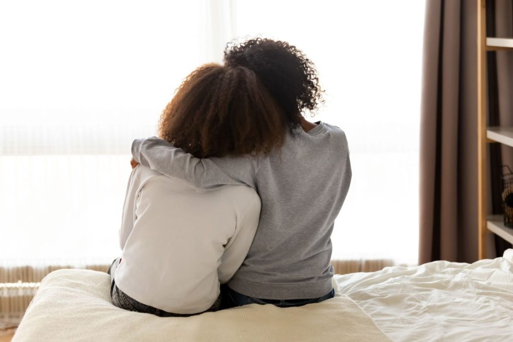 Mom comforting a teen.