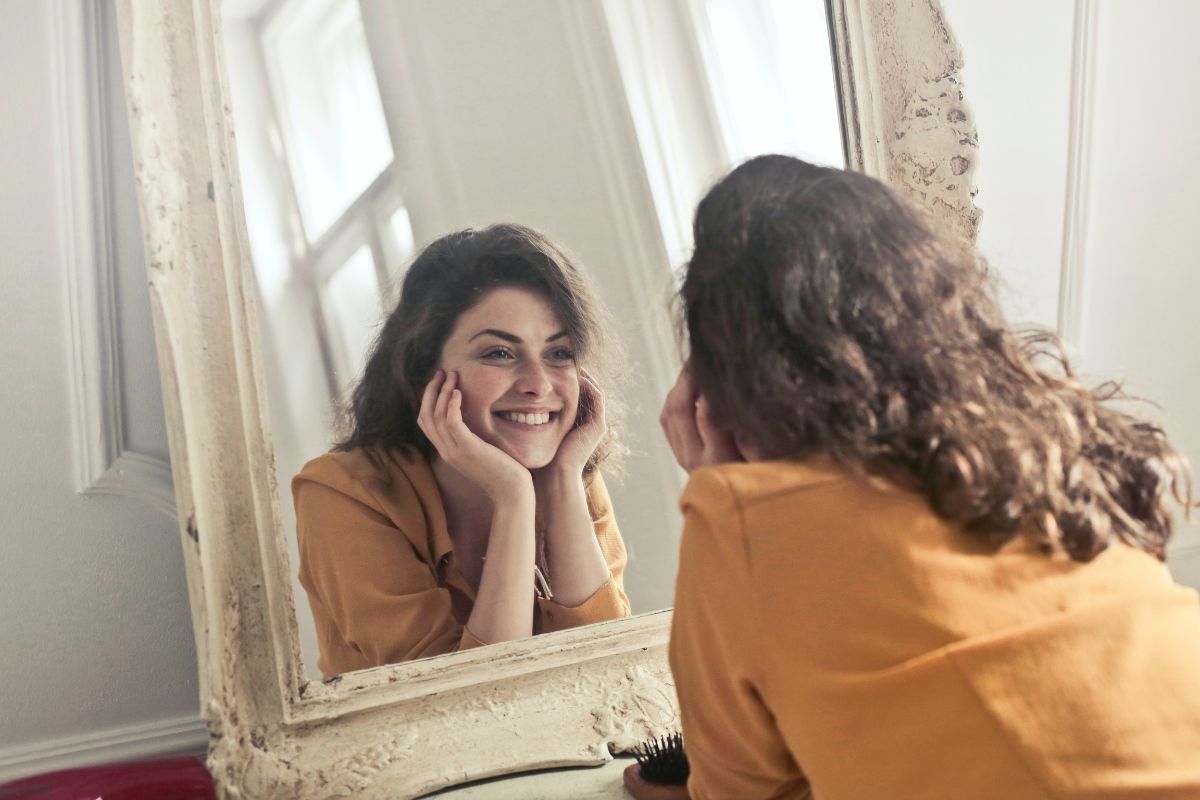 Girl smiling in a mirror