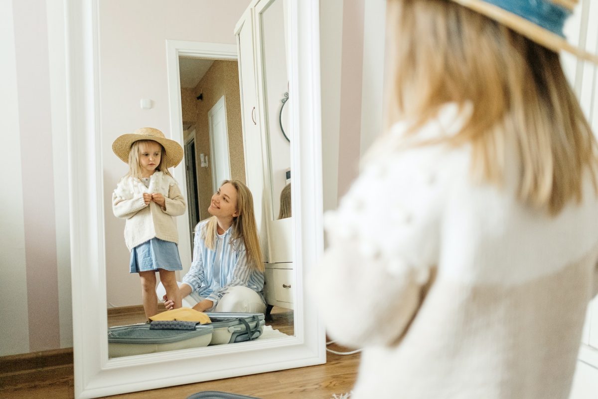 mother and child looking in a mirror