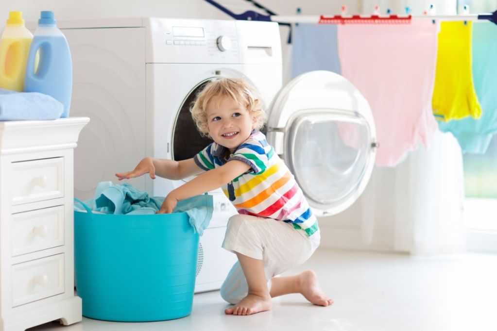 Young boy helping unload the dryer